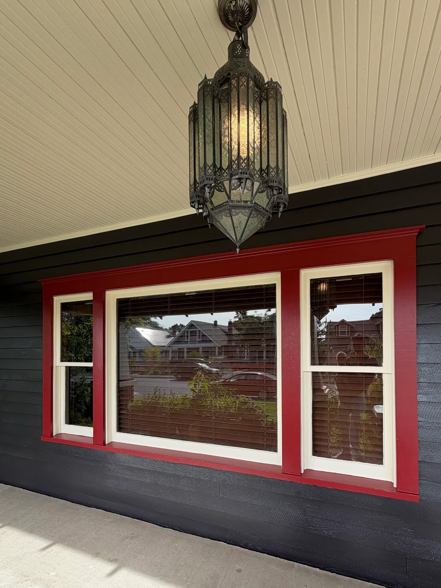 Fresh red and white window trim against dark Craftsman siding